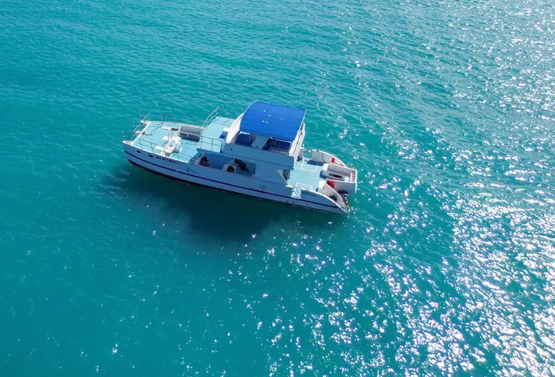 Catamaran on turquoise water, seen from above